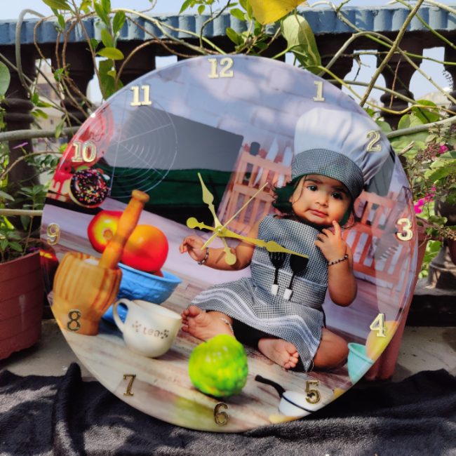 Decorative clock with a child's photo and various items on a garden background